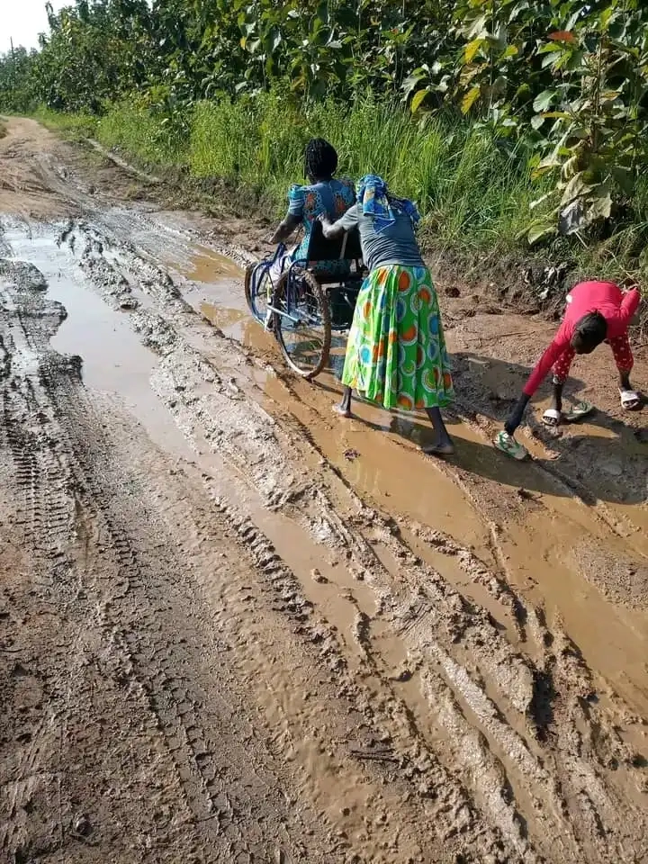 Disable woman on her wheel chair being pushed home along the Hai Peace area in Yei town. File Photo (Access Radio)