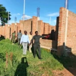 Charles Data showing the new office block to the new commissioner Joseph Mawa. PHOTO CREDIT: Morobo County Press Unit