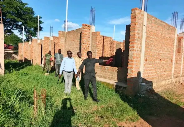 Charles Data showing the new office block to the new commissioner Joseph Mawa. PHOTO CREDIT: Morobo County Press Unit