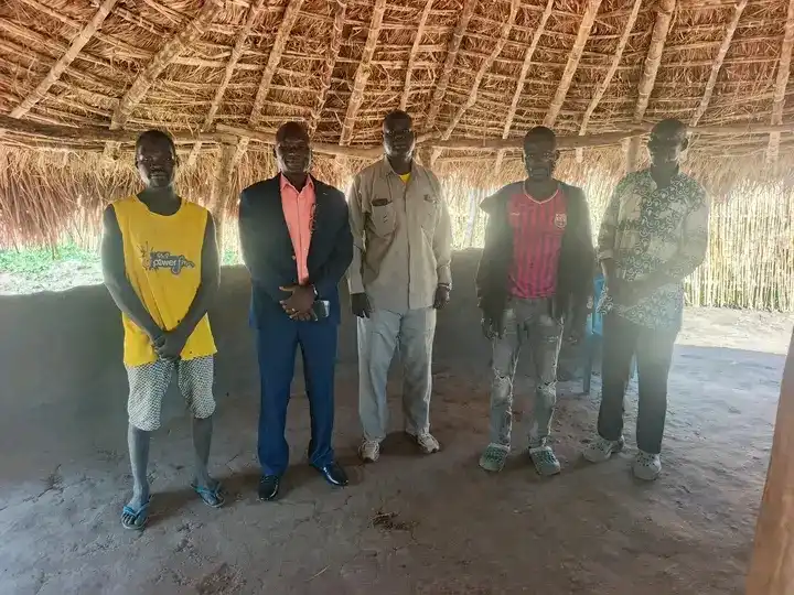 Detained civilians pose for a group photo with County Commissioner OKuba-Photo credit: Press Unity Morobo County