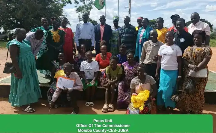 Women pose for a group photo after the meeting-Credit -Morobo County Press Unit