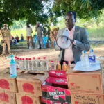 Comissioner inspecting confiscated boxes of alcohol