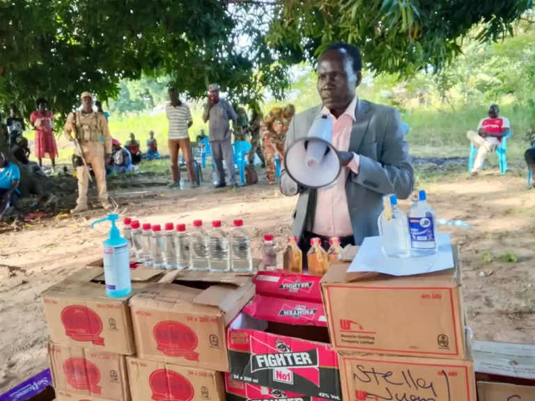 Comissioner inspecting confiscated boxes of alcohol