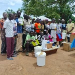 Community members post for a group photo after receiving Beehives in Landili. Photo credit: Christopher Taharir