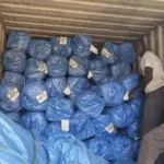 Mosquito nets being unloaded from a truck. Photo credit: James Innocent