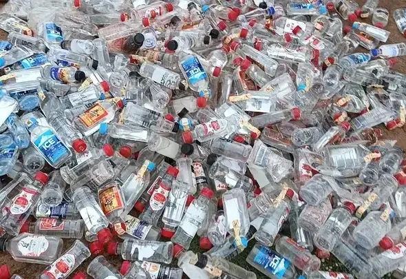 Alcoholic spirits displayed for burning at Yei County head quarters. File Photo (Access Radio)