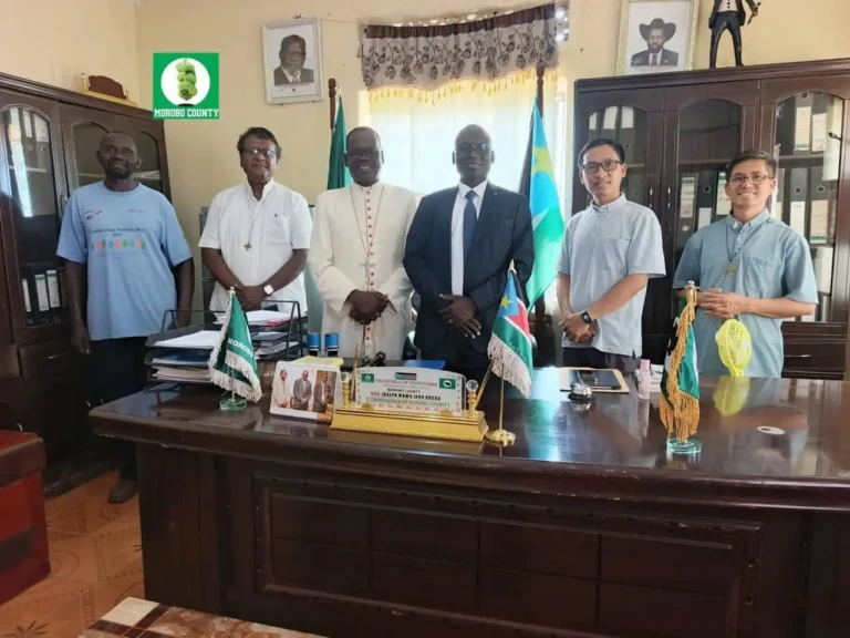Church leaders and Morobo County Commissioner pose for a group photo. Credit: Vita Henry