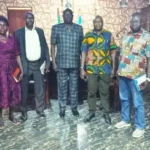 Health officials and the County Commissioner Samuel Malimbo pose for a group photo. Photo Credit: James Innocent