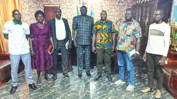 Health officials and the County Commissioner Samuel Malimbo pose for a group photo. Photo Credit: James Innocent