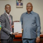 CES Youth Union Chairperson Aggry Duku hands over his 100-day workplan to Governor Emmanuel Adil Athony (Photo CESPU)