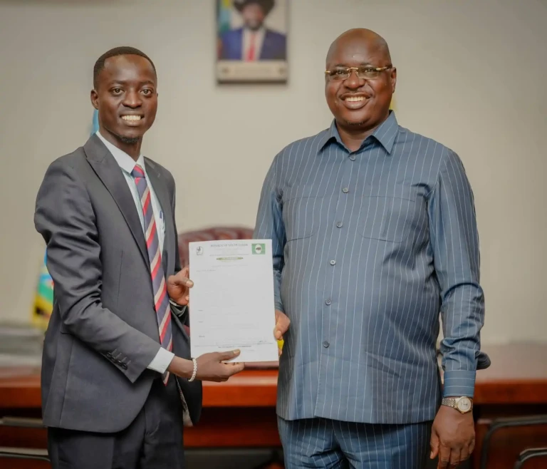 CES Youth Union Chairperson Aggry Duku hands over his 100-day workplan to Governor Emmanuel Adil Athony (Photo CESPU)