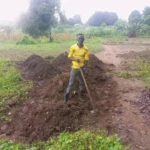 Kissenga Henry in his Farm land