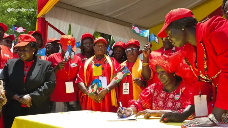 Chairperson of the SPLM Women League sorrouned by colleagues while signing the constitution at the SPLM House (2)