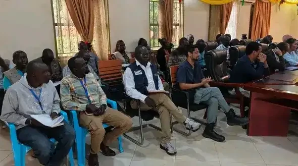 Humanitarian and Government officials in a joint partners meeting