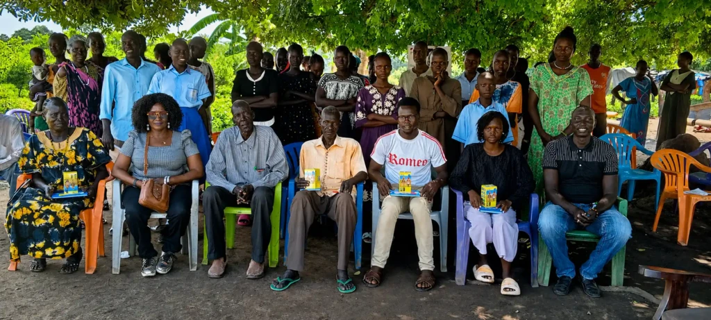 Leaders of the Community Engagament Groups siting infront joined by Women Foundation for Humanity officials for a group photo