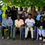 Leaders of the Community Engagament Groups siting infront joined by Women Foundation for Humanity officials for a group photo