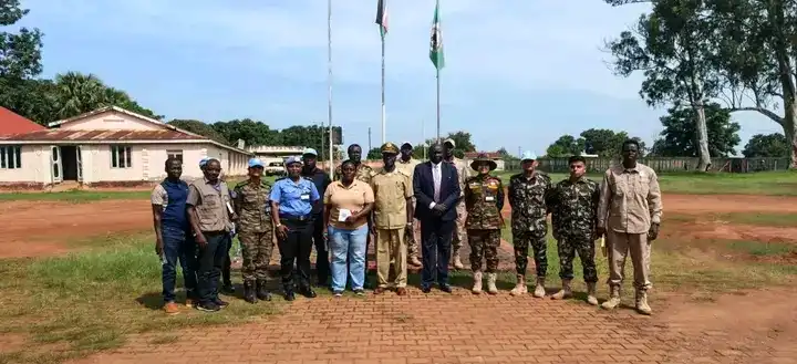 Yei commissioner Center with UNMISS officials in a group photo