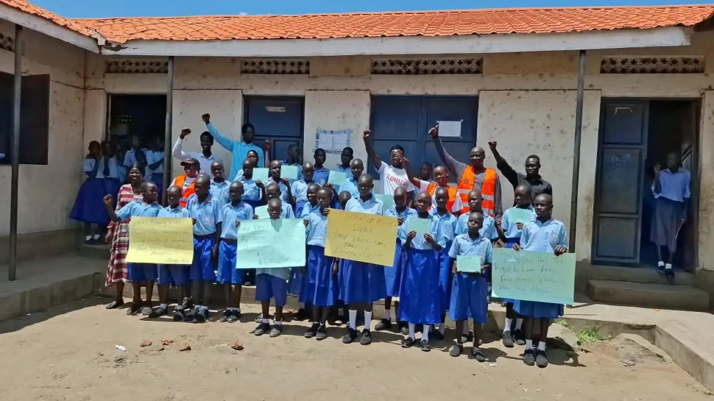 Pupils pose for a photo with teachers and staff from Human Foundation for Humanity after the debate