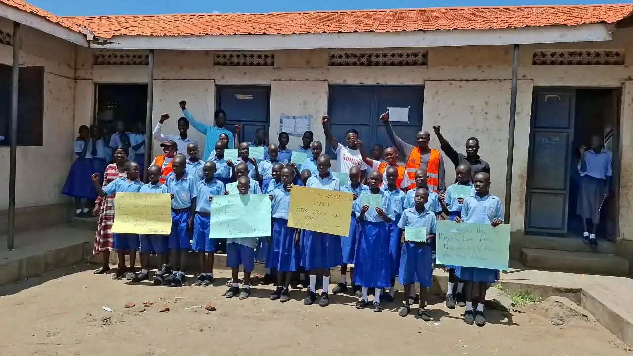 Pupils pose for a photo with teachers and staff from Human Foundation for Humanity after the debate