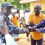 Kajo-Keji Chief in Orange Shirt handed over by Uganda Police