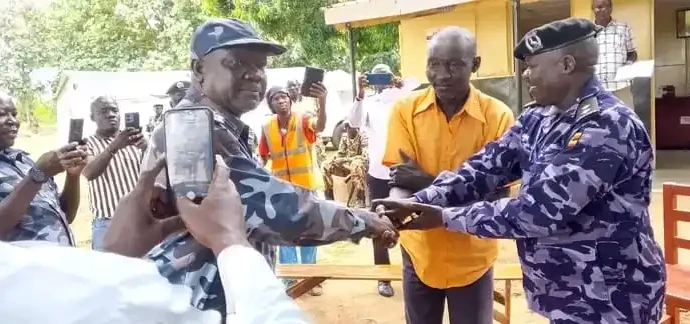 Kajo-Keji Chief in Orange Shirt handed over by Uganda Police
