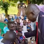 Kajo-Keji Commisisoner administering Polio vaccine to children in Kajo-Keji