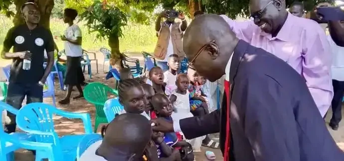 Kajo-Keji Commisisoner administering Polio vaccine to children in Kajo-Keji